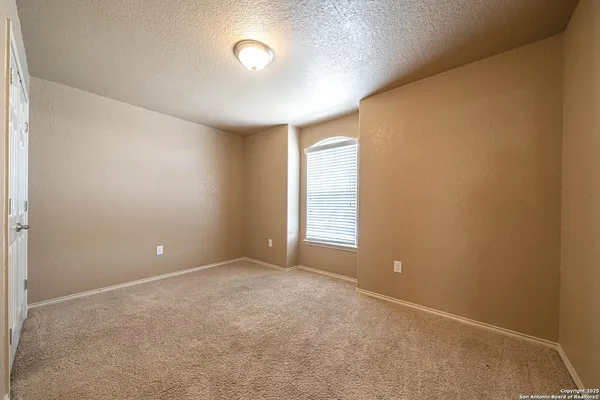 an empty room with windows and closet