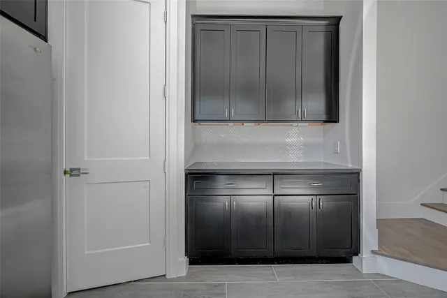 a kitchen with a refrigerator and cabinets