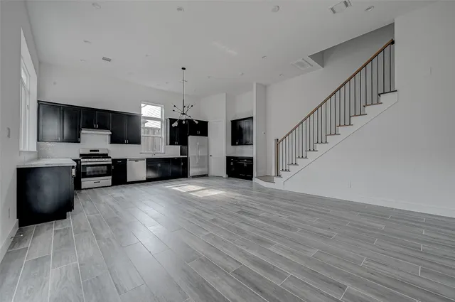 a view of kitchen with sink microwave and refrigerator