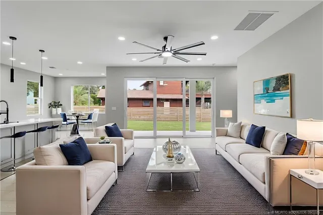 a kitchen with stainless steel appliances granite countertop a sink a stove a refrigerator and a microwave