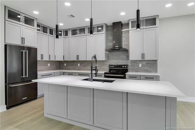a view of kitchen with refrigerator and wooden floor