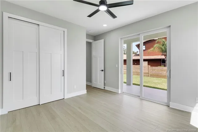 a spacious bedroom with a bed and a flat screen tv