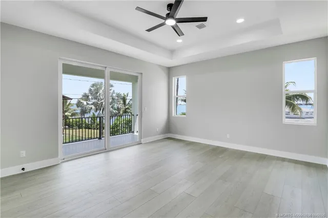 wooden floor in an empty room with a bathroom