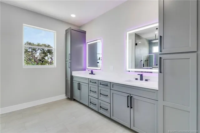 a bathroom with a bathtub shower sink vanity and toilet