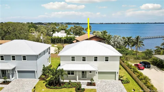 an aerial view of a houses with a lake