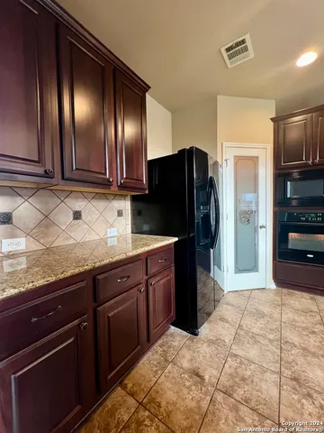 a kitchen with stainless steel appliances granite countertop a stove microwave and cabinets