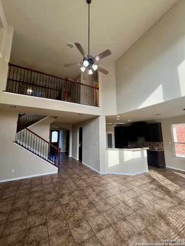 a view of an empty room with a fireplace and a window