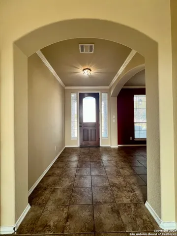 a view of a hallway with an entryway and chandelier