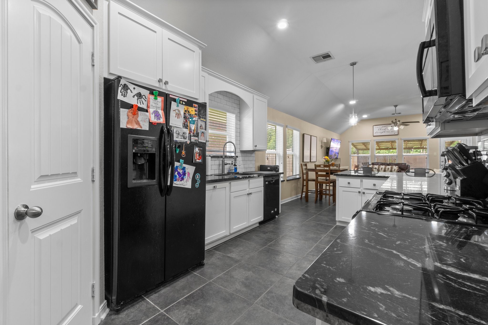 28987 Birch Green Way Spring, TX 77386 - Photo 7 of 32 a kitchen with stainless steel appliances granite countertop a refrigerator a stove and a sink with wooden floor