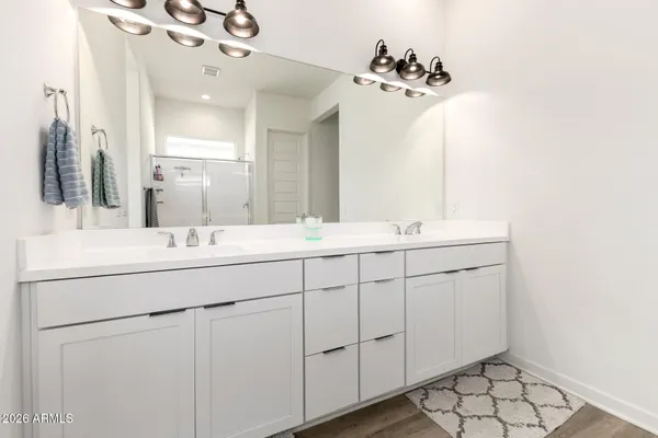 a bathroom with a double vanity sink and a mirror