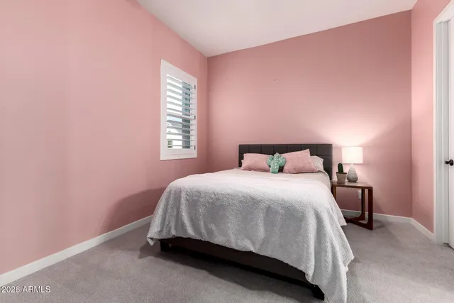 a bedroom with a bed and window