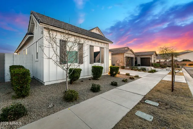 a view of a house with backyard sitting area and garden