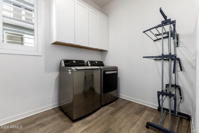 a utility room with closet dryer and washer