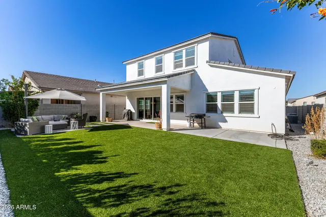 a front view of a house with a garden and patio