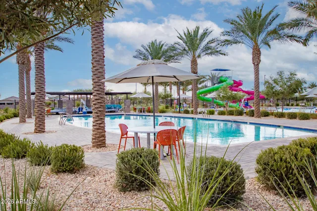a view of a chairs and table in patio with a lake view