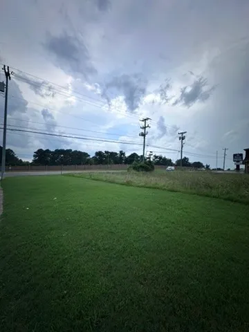 a view of building with outdoor space and yard