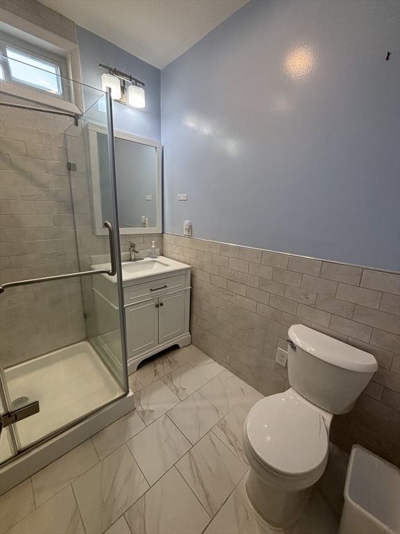 30 Alaric Street, Unit 2 Boston, MA 02132 - Photo 8 of 14 a bathroom with a toilet sink and mirror