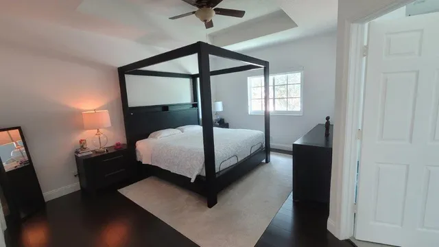 a bedroom with a bed window and a table