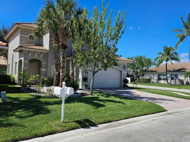 a view of a house with a yard and plants
