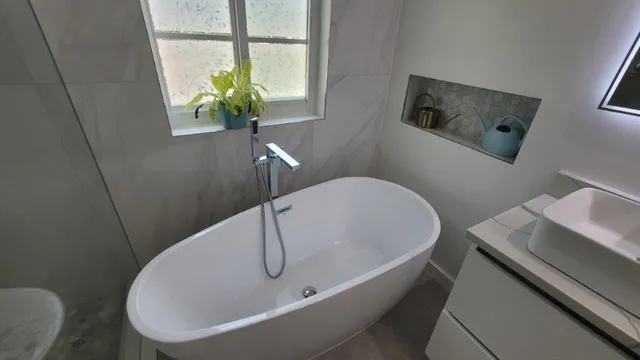 a white bath tub sitting in a bathroom