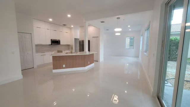 a view of kitchen with kitchen island and stainless steel appliances