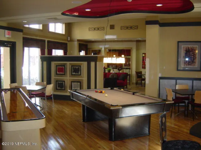 a room with pool table table and window
