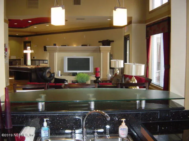 a living room with fireplace and flat screen tv