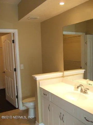 a bathroom with a sink a toilet a tub and shower