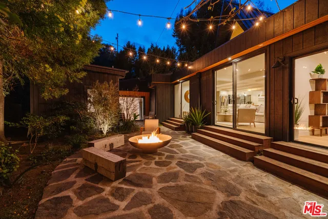 a view of a porch with furniture and a yard