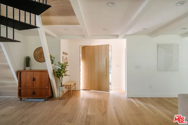 a view of an entryway with wooden floor