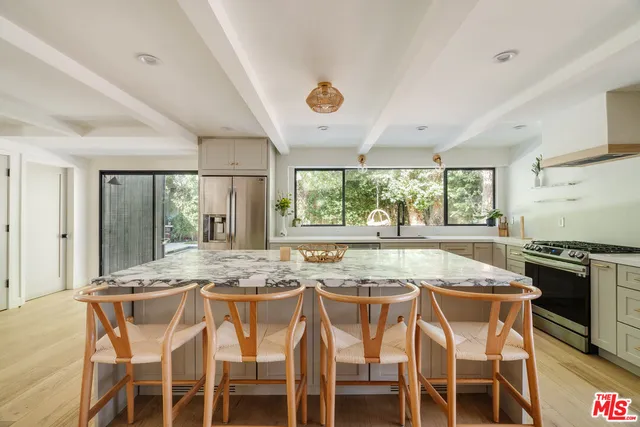 a dining table with chairs and window
