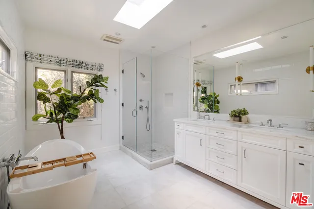 a spacious bathroom with a double vanity sink and a mirror