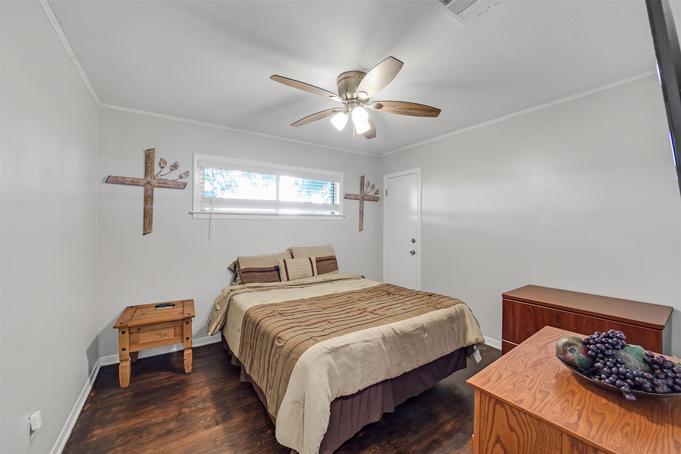9606 Needville Fairchilds Road Needville, TX 77461 - Photo 26 of 46 a bedroom with a bed and a chandelier