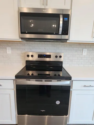 a stove top oven sitting inside of a kitchen