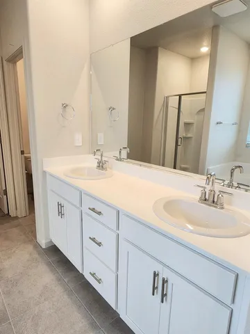 a bathroom with a glass shower door
