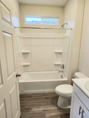 a bathroom with a toilet and a shower