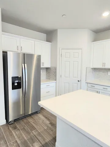 a kitchen with stainless steel appliances a refrigerator and a stove