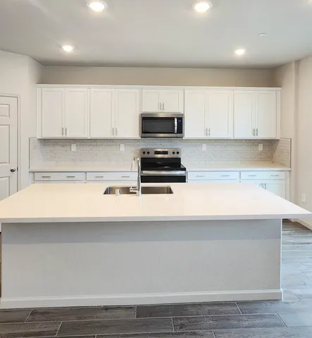 a kitchen with a white cabinets and white appliances