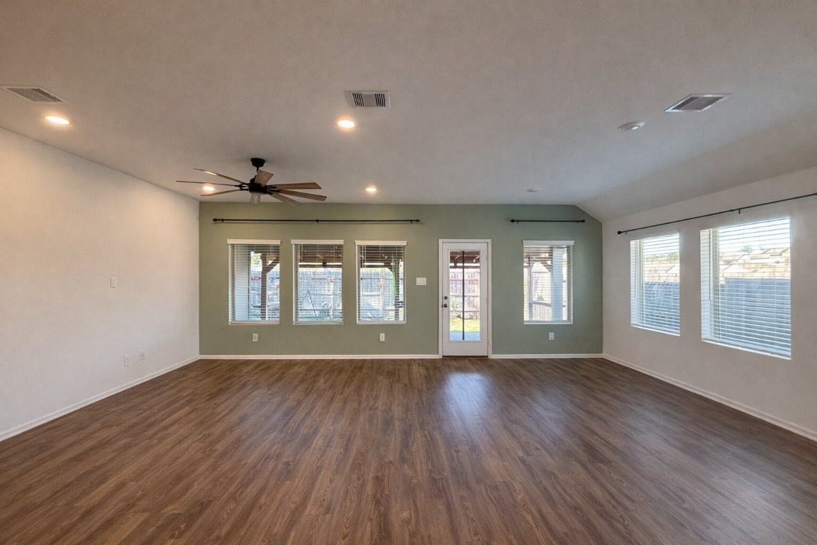 3105 Catalonion Court Conroe, TX 77301 - Photo 15 of 16 a view of an empty room with a window and wooden floor