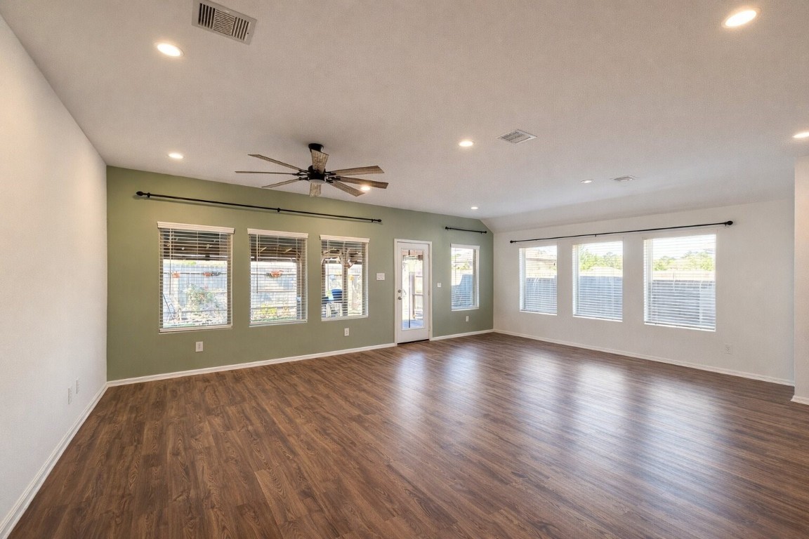 3105 Catalonion Court Conroe, TX 77301 - Photo 4 of 16 a view of an empty room with wooden floor and a window