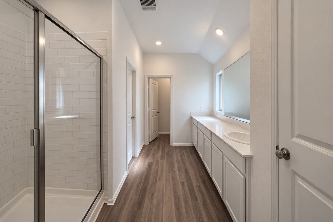 3105 Catalonion Court Conroe, TX 77301 - Photo 6 of 16 a bathroom with a sink and a mirror
