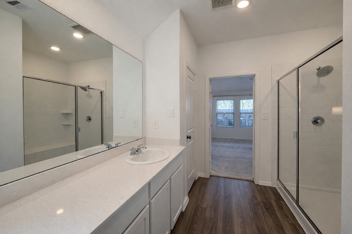 3105 Catalonion Court Conroe, TX 77301 - Photo 7 of 16 a spacious bathroom with a shower sink and mirror
