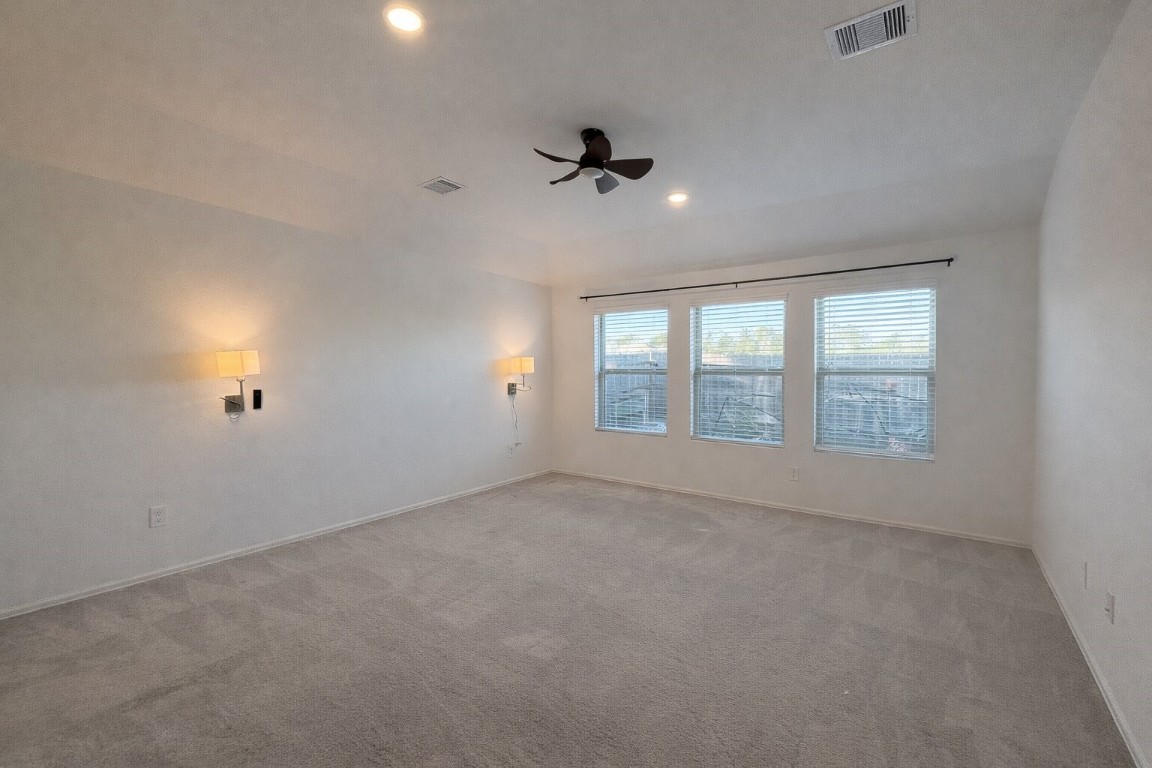 3105 Catalonion Court Conroe, TX 77301 - Photo 8 of 16 an empty room with windows and ceiling fan