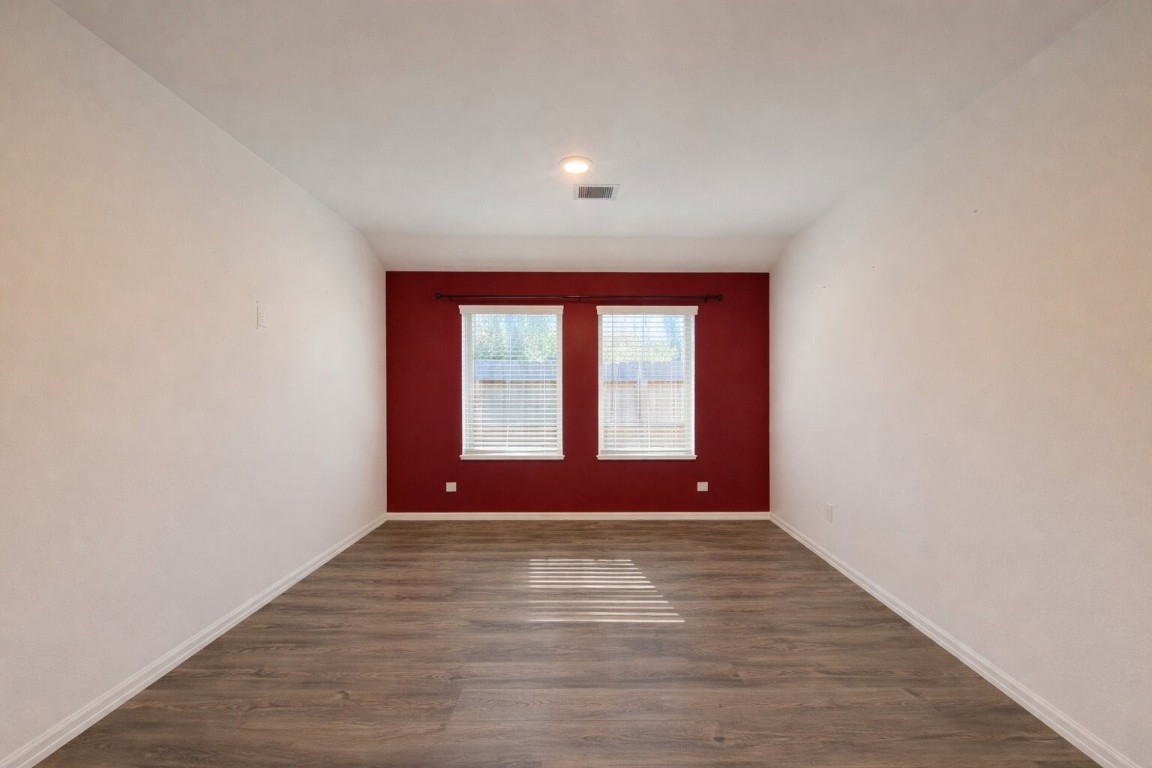 3105 Catalonion Court Conroe, TX 77301 - Photo 9 of 16 a view of empty room with wooden floor and fan