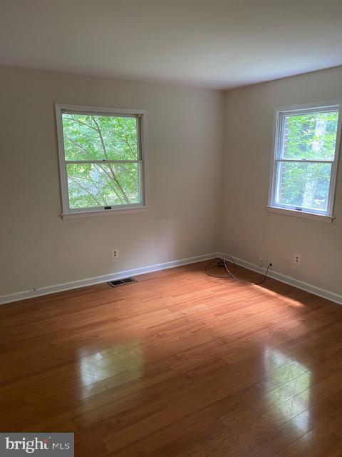 9290 Windrush Drive Lorton, VA 22079 - Photo 6 of 15 a view of an empty room with wooden floor and a window