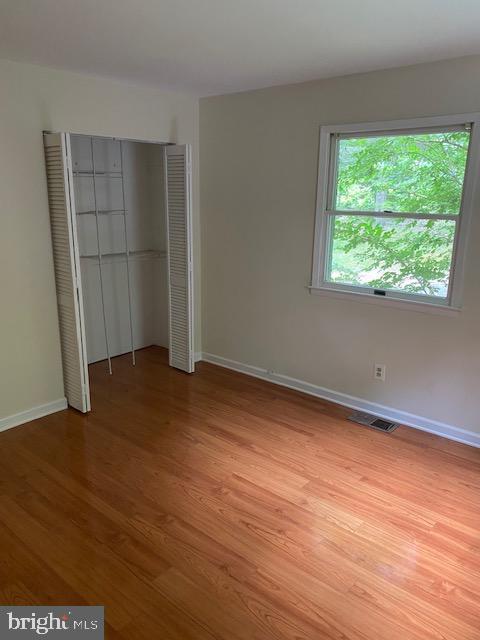 9290 Windrush Drive Lorton, VA 22079 - Photo 8 of 15 an empty room with wooden floor and a window
