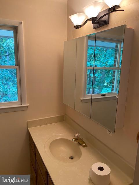 9290 Windrush Drive Lorton, VA 22079 - Photo 9 of 15 a bathroom with a granite countertop sink and a mirror