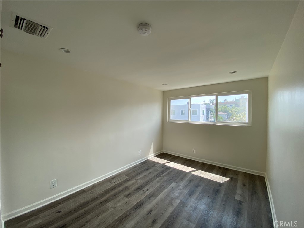 208 South Park View Street, Unit 2 Los Angeles, CA 90057 - Photo 16 of 24 an empty room with wooden floor and windows
