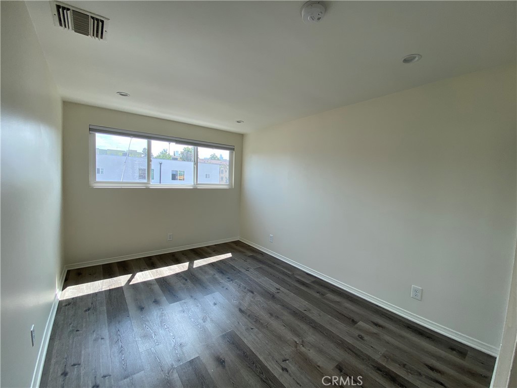 208 South Park View Street, Unit 2 Los Angeles, CA 90057 - Photo 18 of 24 an empty room with wooden floor and windows