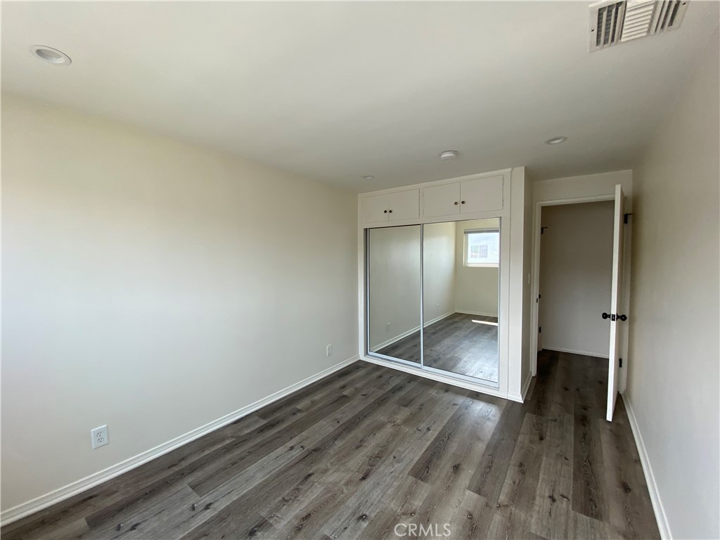 208 South Park View Street, Unit 2 Los Angeles, CA 90057 - Photo 19 of 24 a view of an empty room with wooden floor and a window